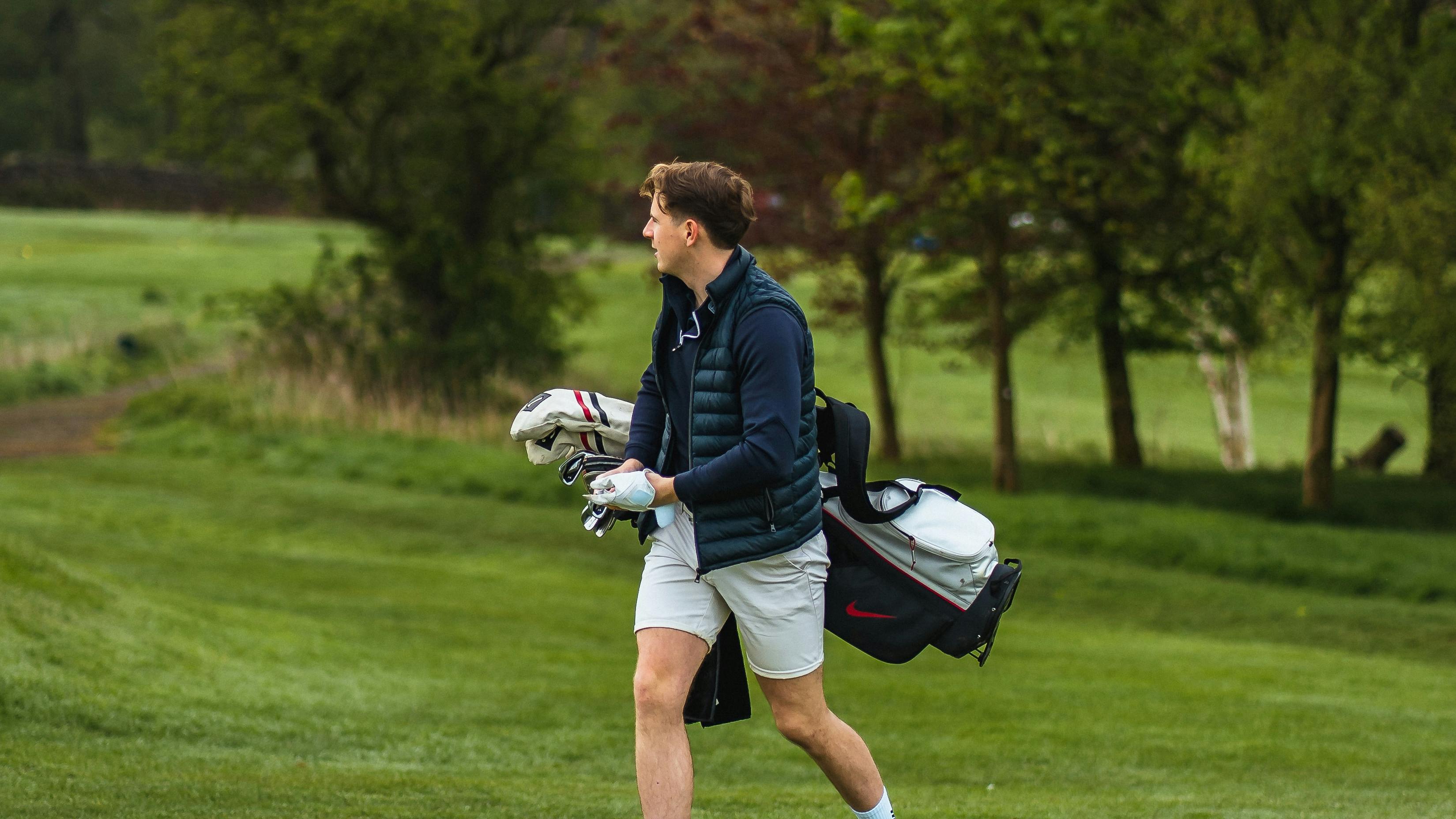 Golfer carrying bag 