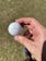White Wilson Staff Model golf ball in a hand outside