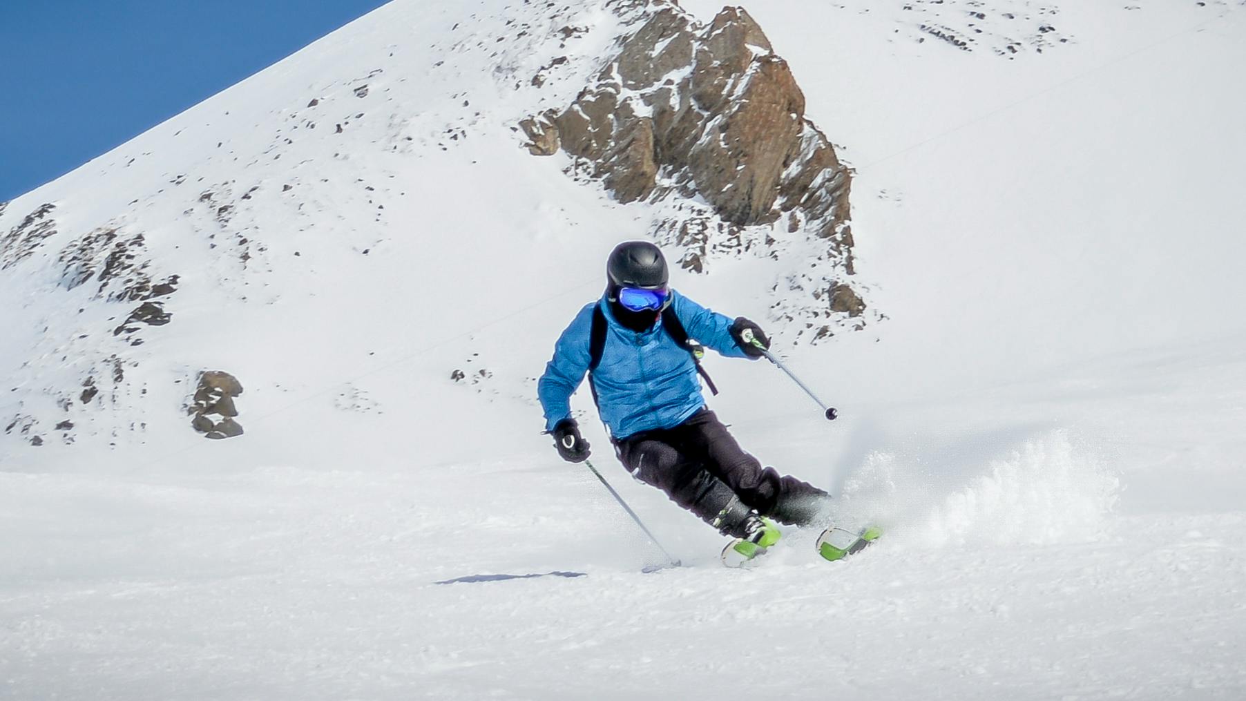 A skier carves a turn.