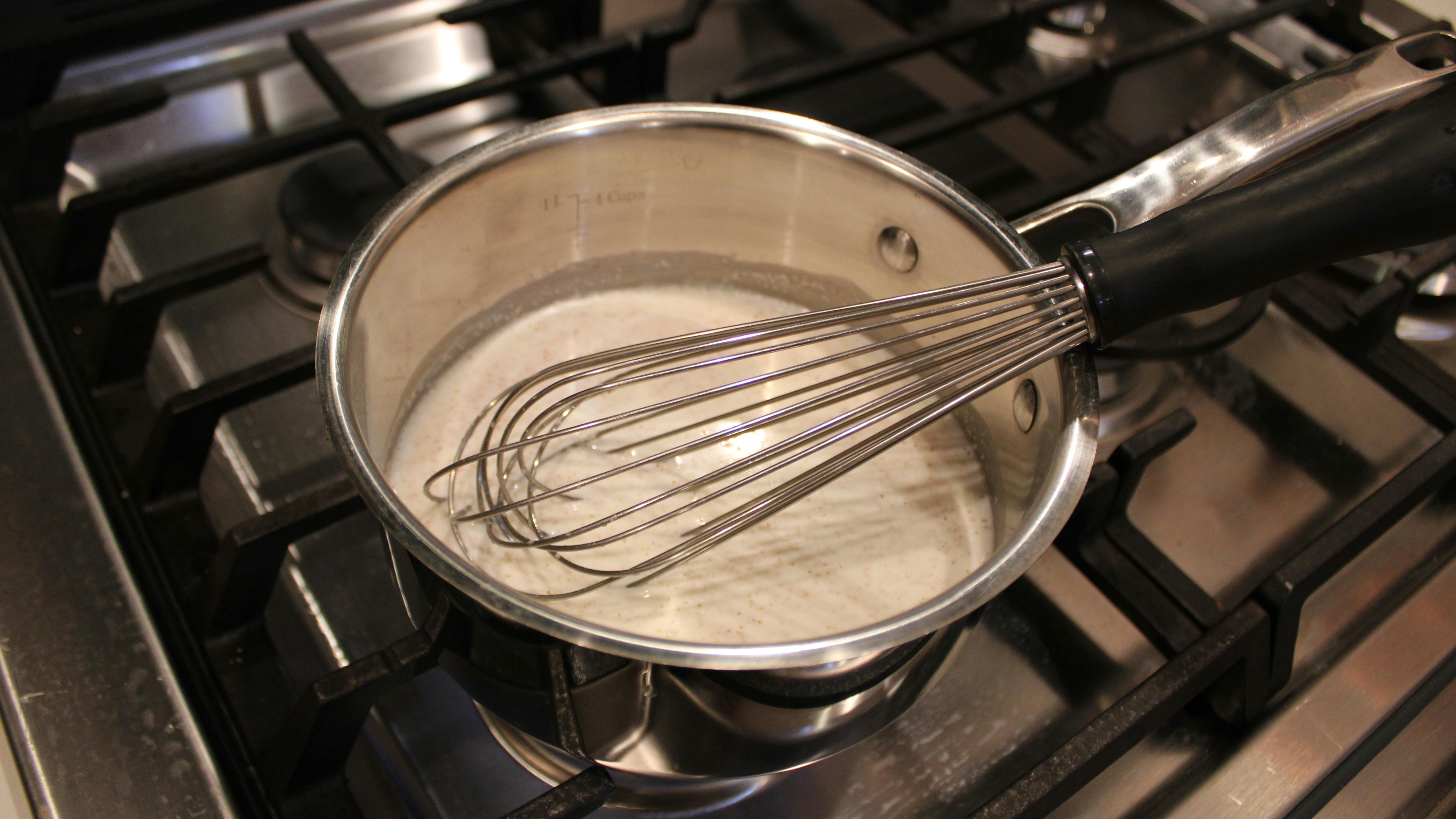 Whisk in a saucepan with white gravy as it sits on the stove. 