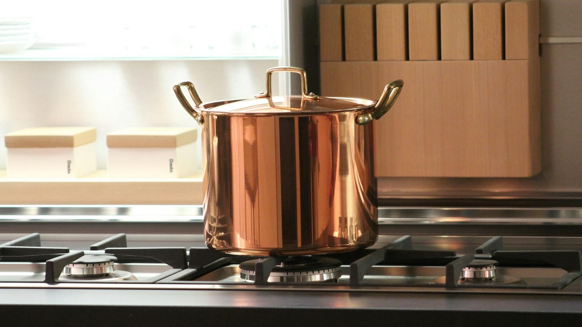 A stockpot with a full copper exterior.