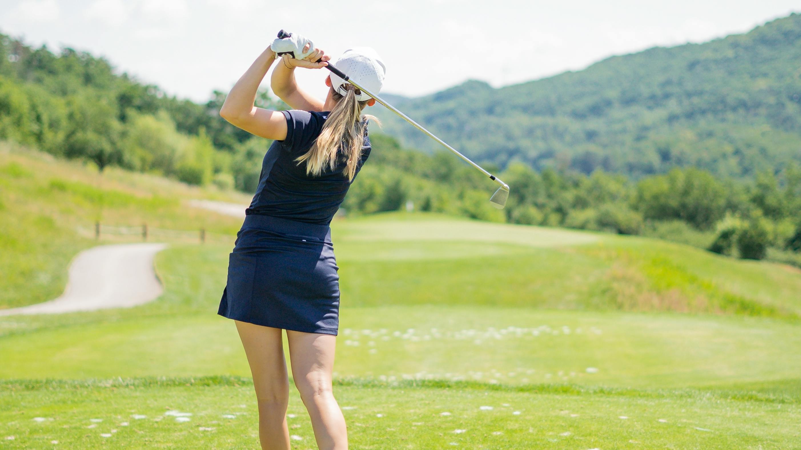 Female golfer playing a round on the course.