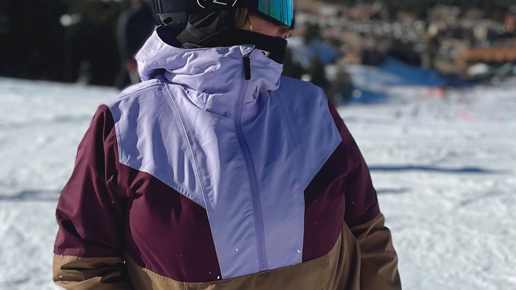 A snowboarder wearing the Volcom Women's Mirror 2L Pullover. 