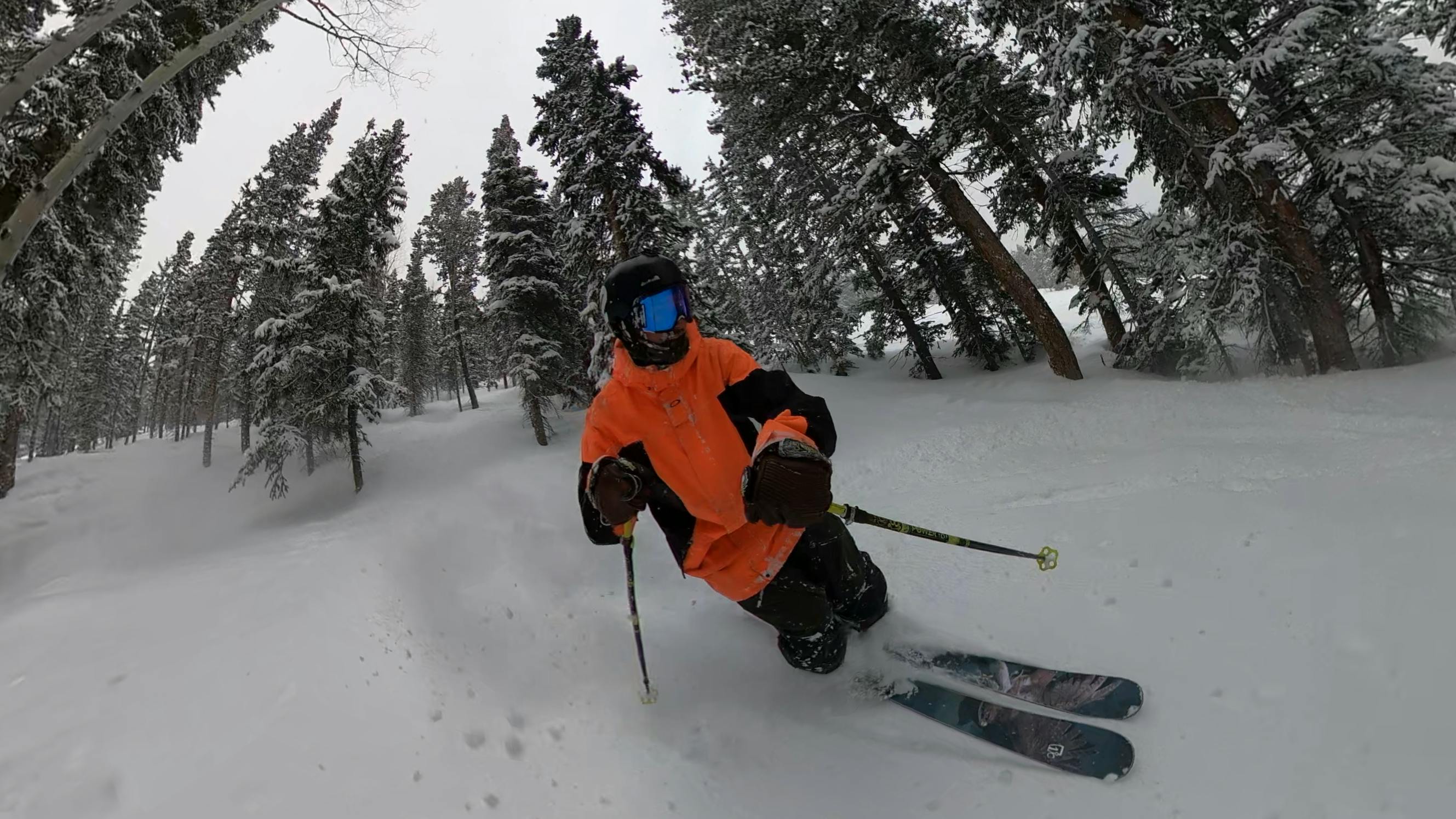 A skier on the Icelantic Nomad 105 Skis. 