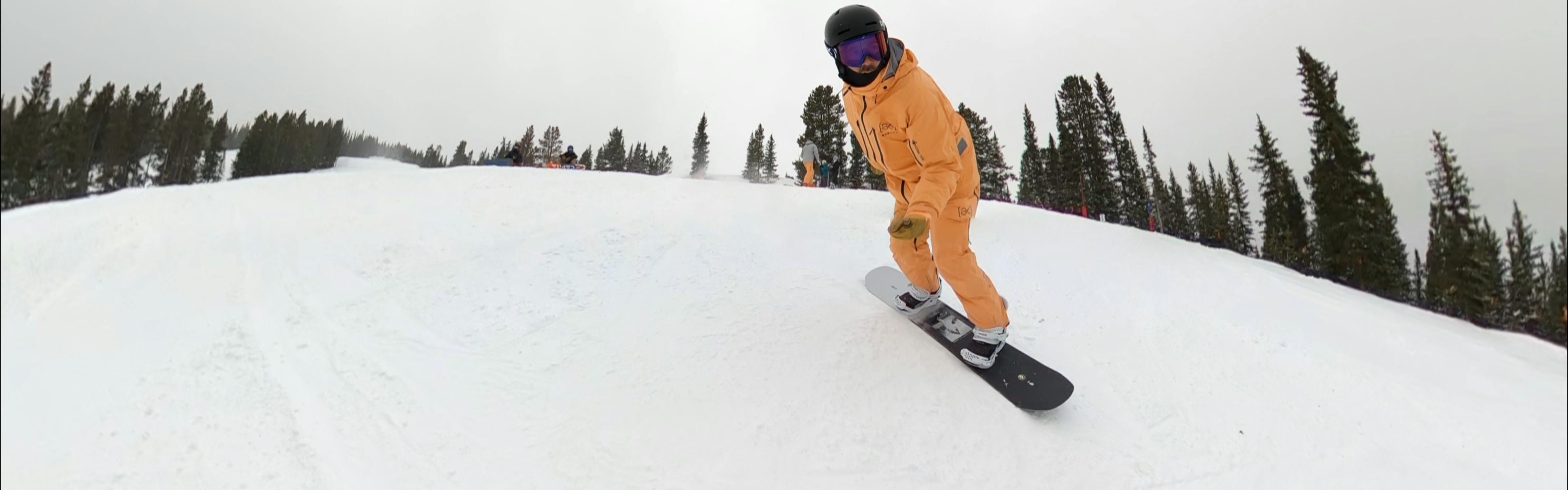 A snowboarder on the CAPiTA Super Defenders of Awesome Snowboard.