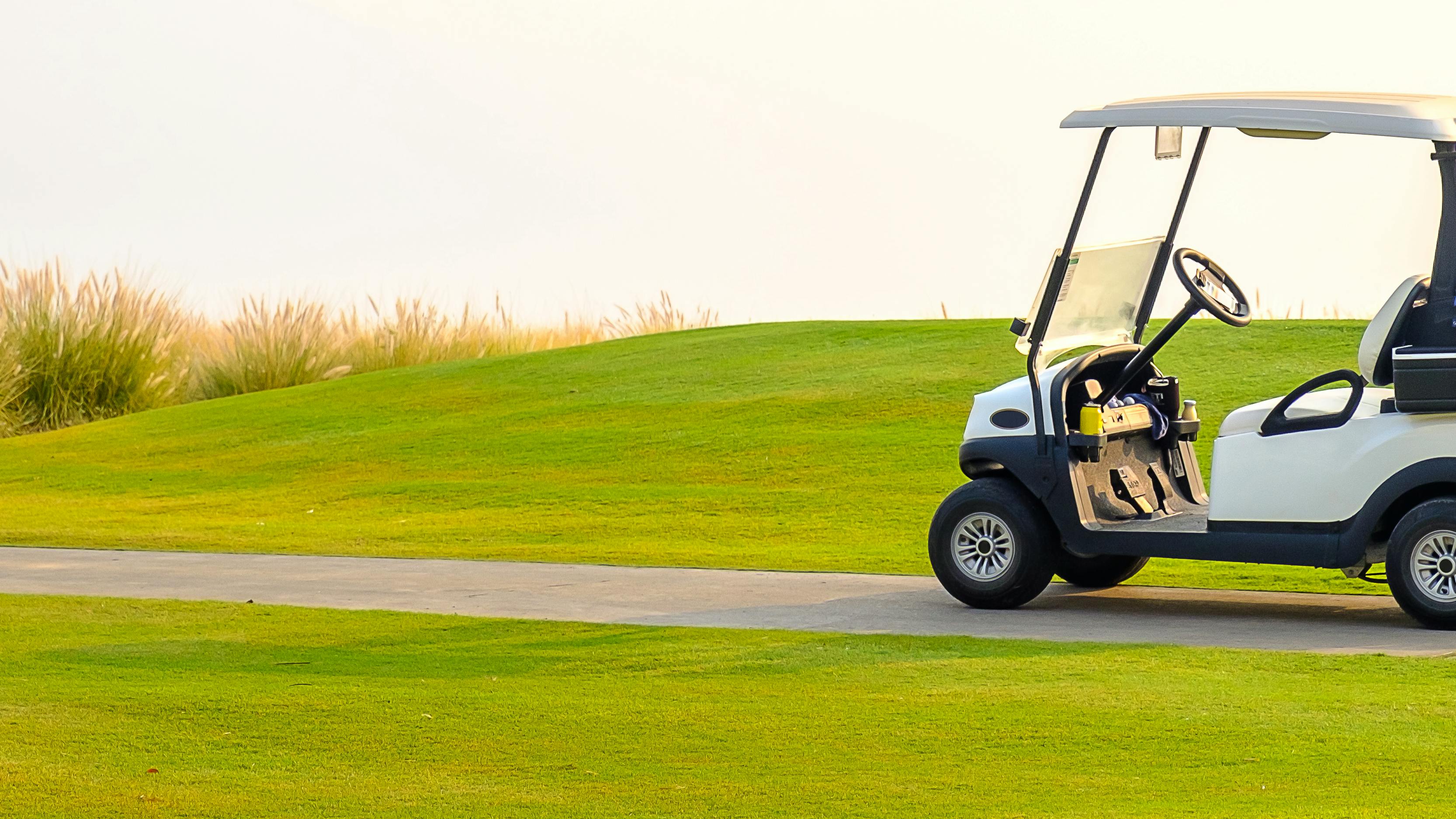 A golf cart on a golf course. 