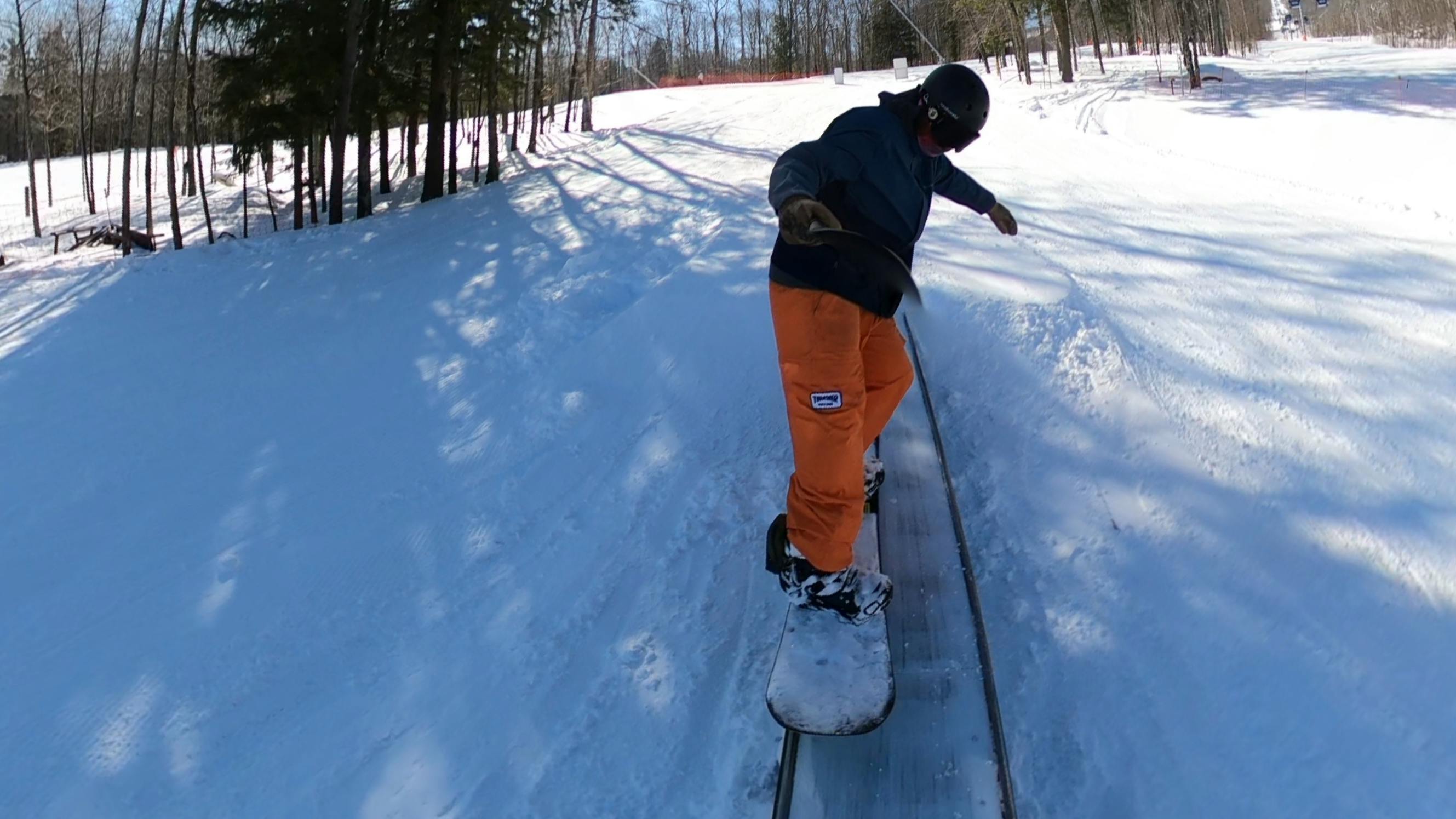 A snowboarder on the Rome Mechanic Snowboard.