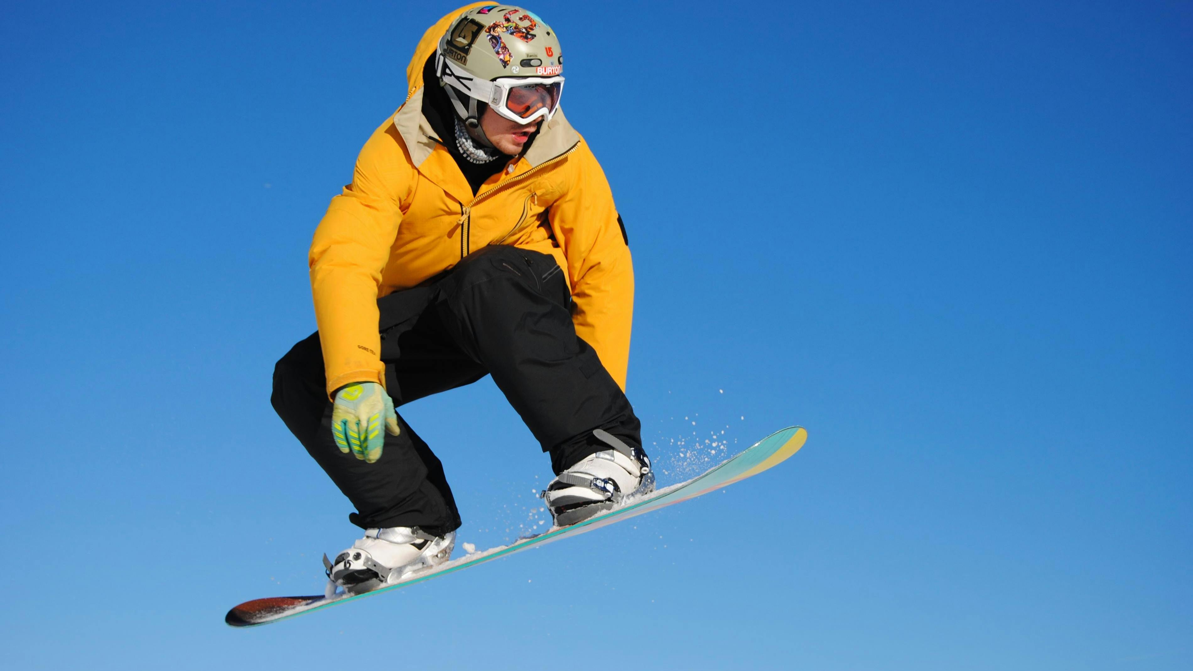 A snowboarder doing a jump. 