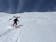 Female skier descending a backcountry slope. 