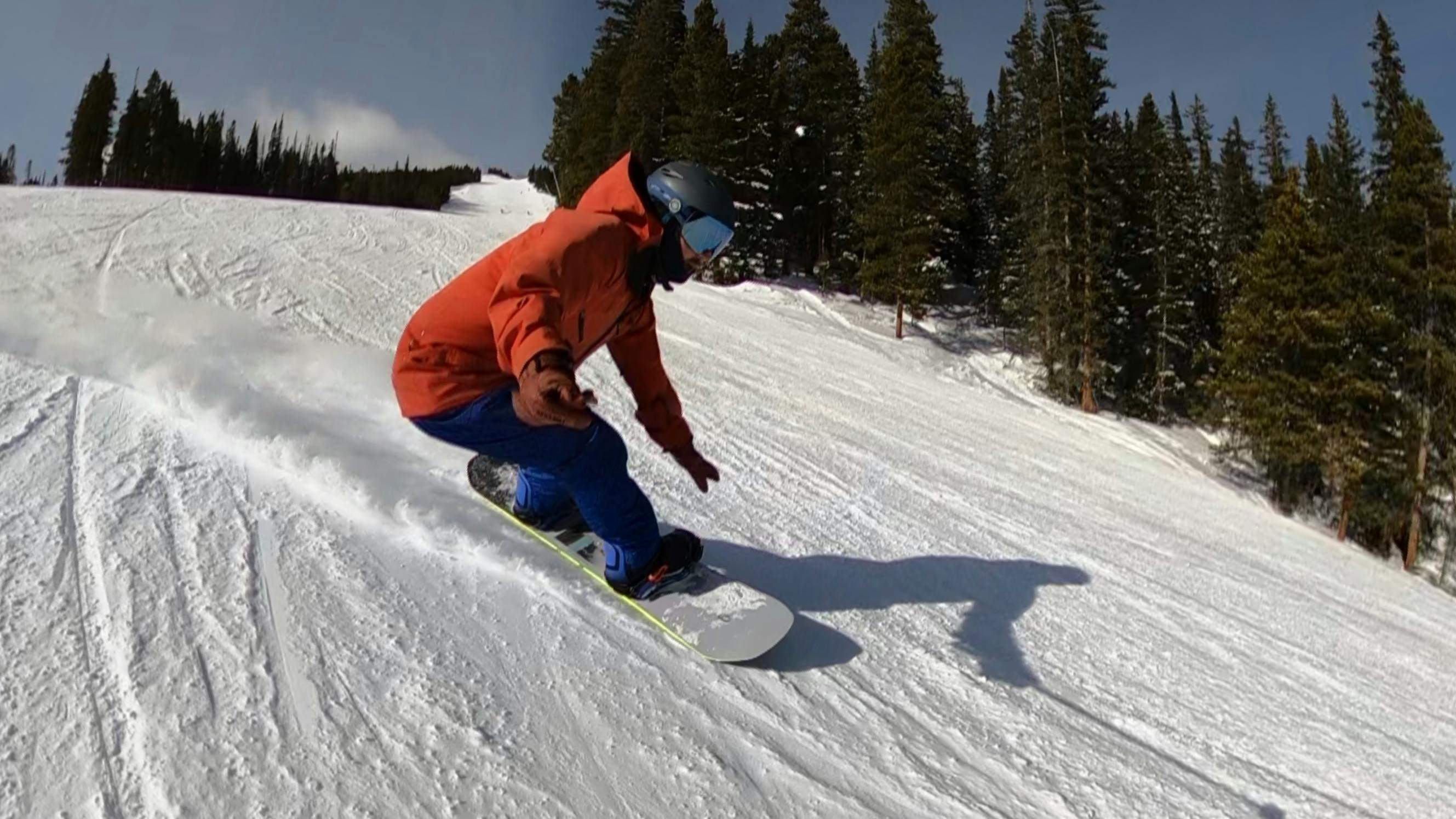 A snowboarder on the CAPiTA Defenders of Awesome Snowboard. 