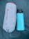 Gray sleeping pad is rolled into it's stuff sack and compared to a 32 oz waterbottle. The pad is larger than the bottle. 
