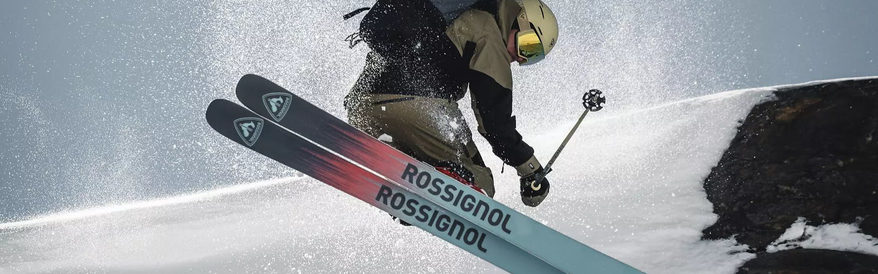 The bottom of a pair of Rossignol skis as a skier does a trick on them. 