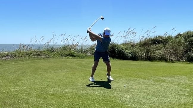 A golfer taking a swing with a golf club. 