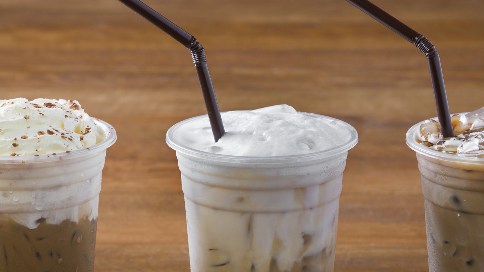 Three iced espresso drinks sitting together. 