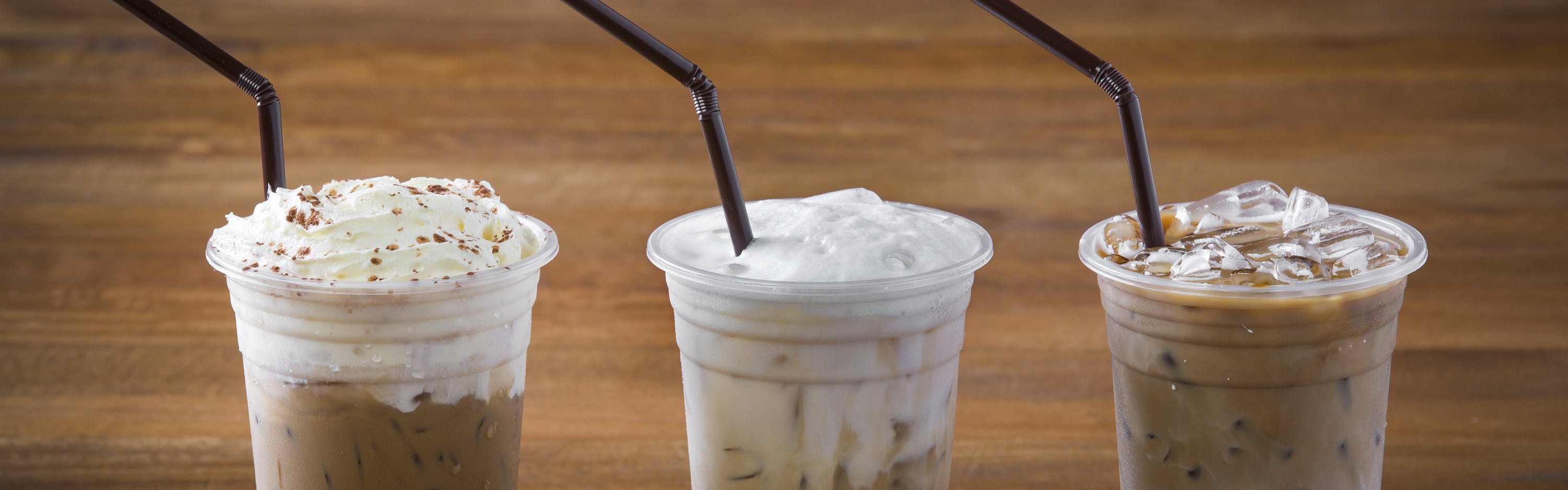Three iced espresso drinks sitting together. 