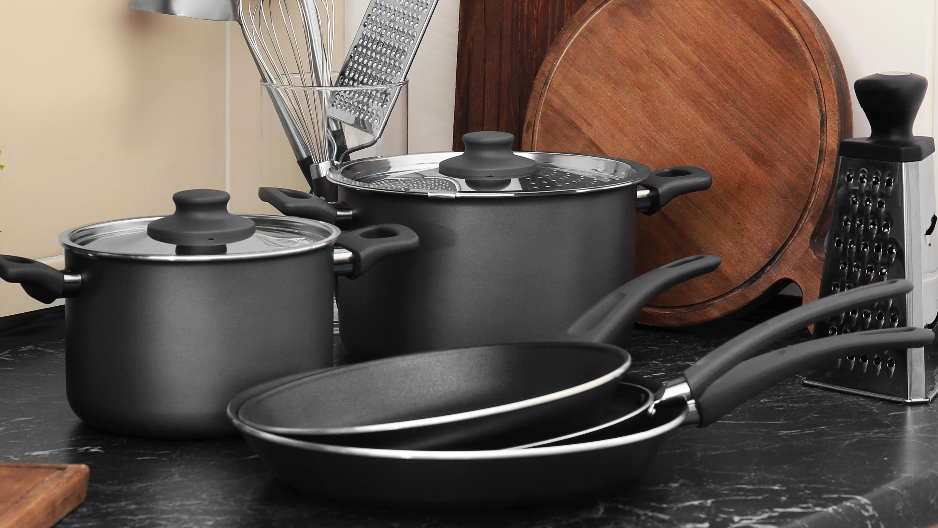 Several types of cookware laying on a counter. 