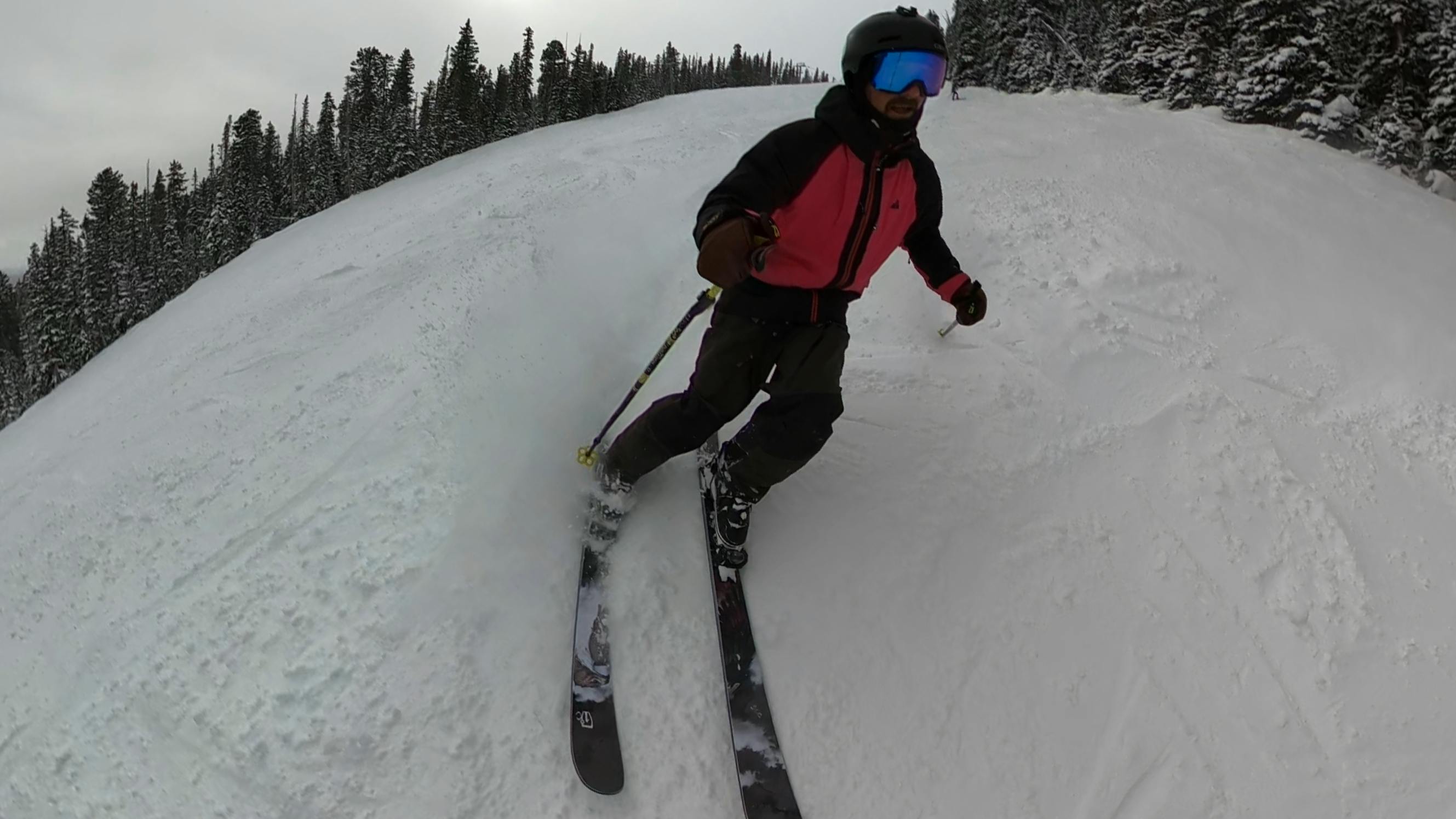 A skier on the 2024 Icelantic Nomad 95 Skis.