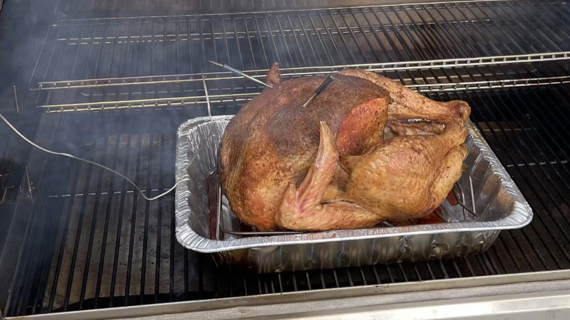 A chicken roasting on a pellet grill. 