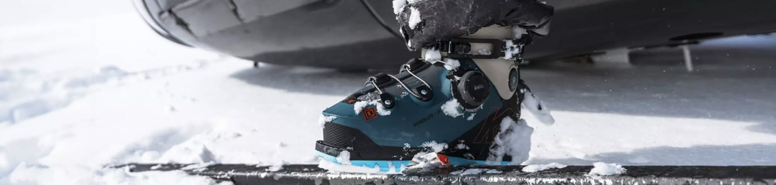A skier buckling his K2 Ski Boots. 