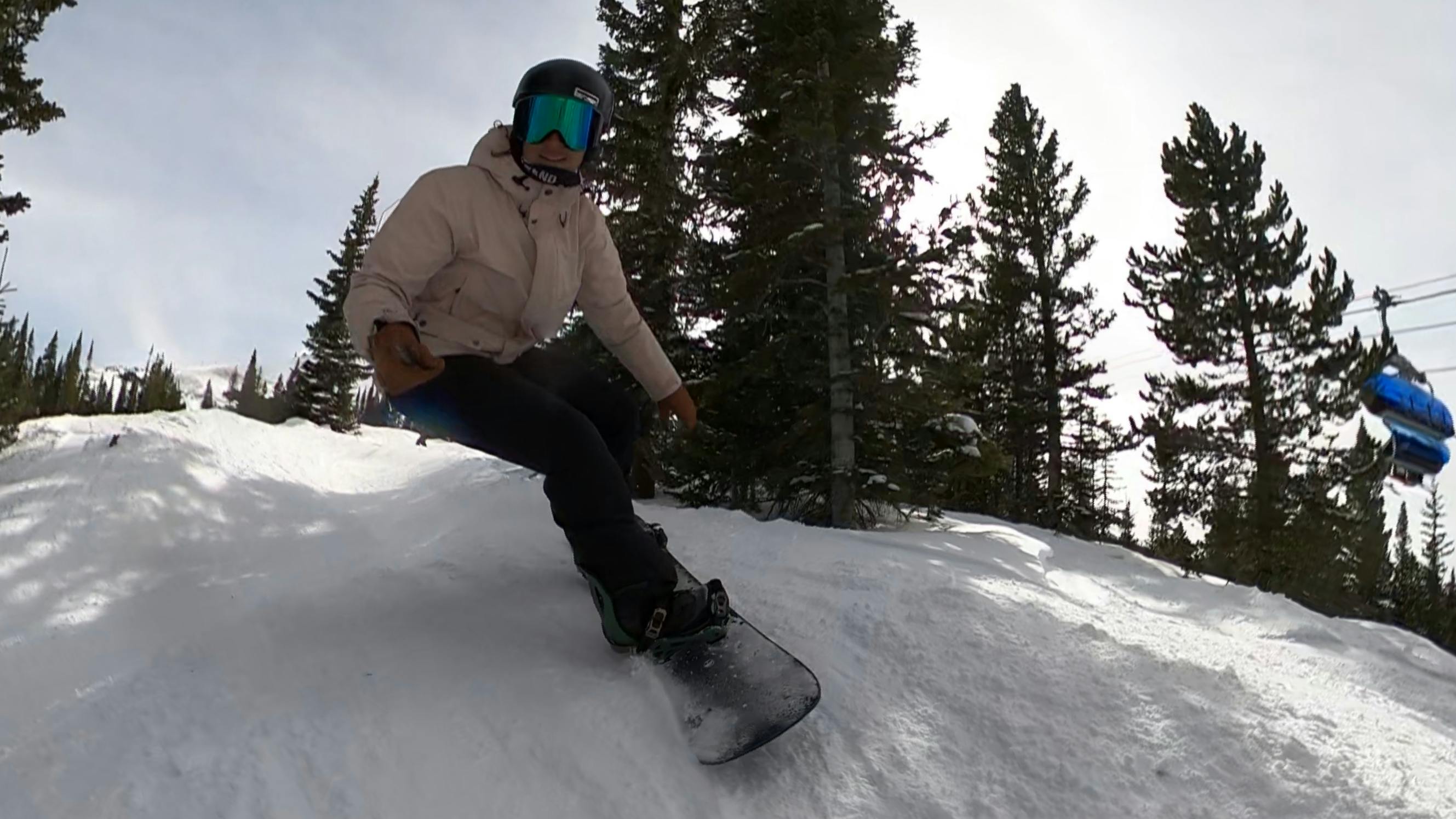 A snowboarder on the Arbor Draft Camber Snowboard.