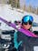 Girl with skis on shoulder and googles pushed up onto helmet with the low light lenses (blue) installed.