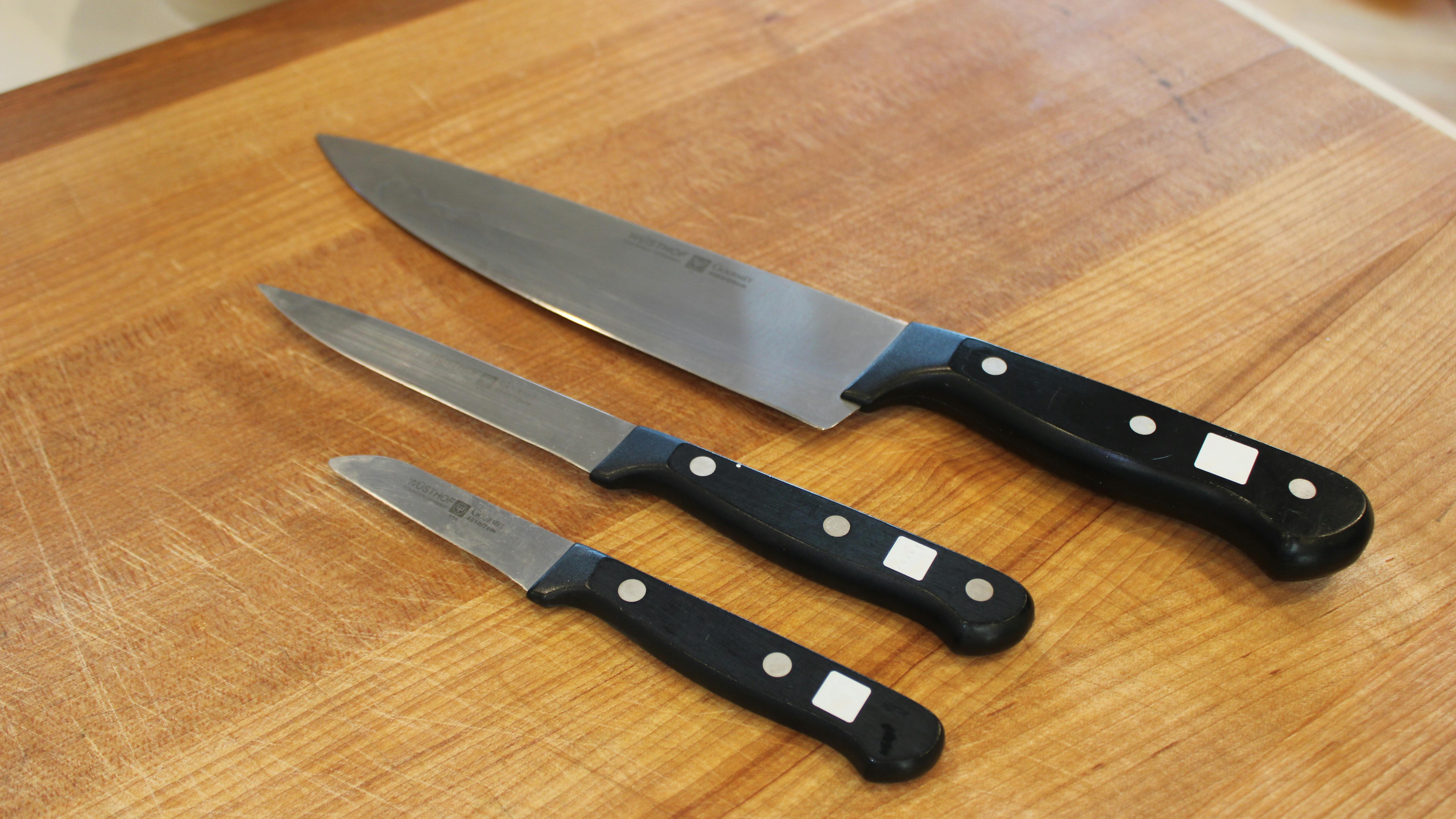 Three chef's knives set on wood block.