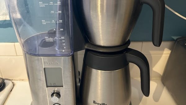 Breville Precision Brewer Thermal Coffee Maker sitting on a kitchen counter.