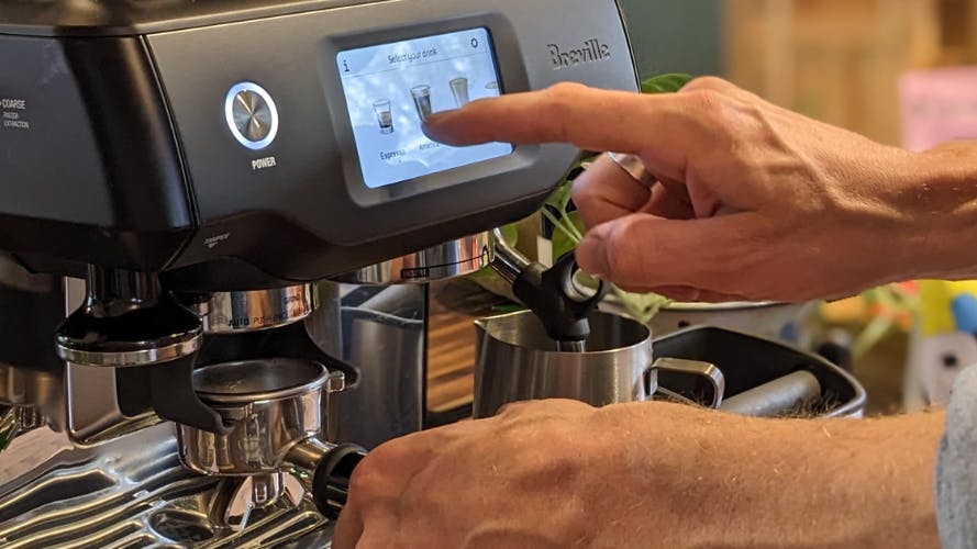 Barista using The Breville Barista Touch touchscreen