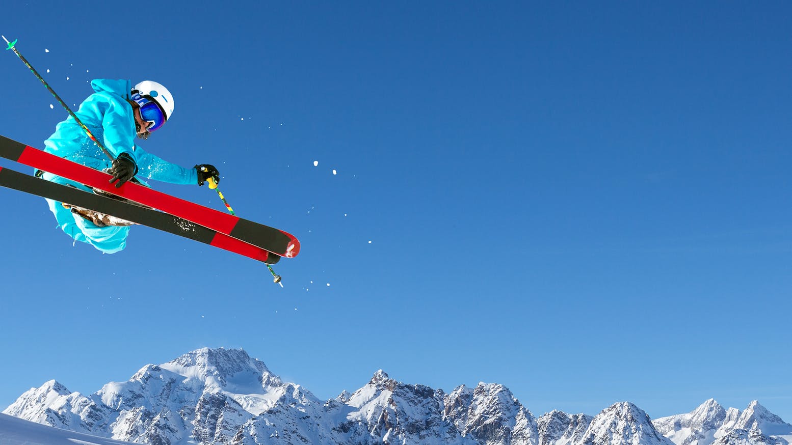 A skier jumps on his twin tip skis. 