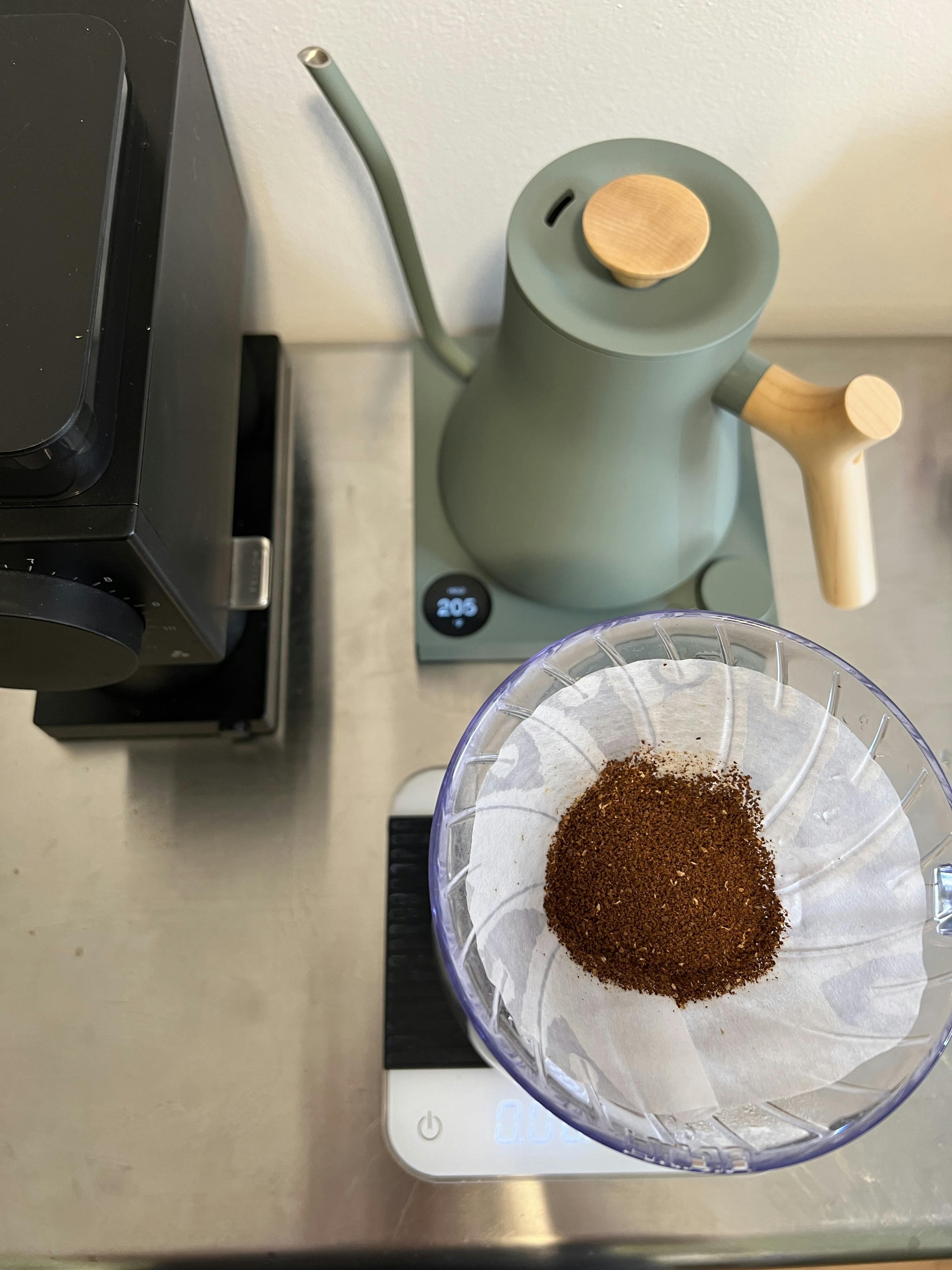 Professional barista preparing coffee using chemex pour over coffee maker  and drip kettle. Young woman making coffee. Alternative ways of brewing  coffee. Coffee shop concept. Stock Photo