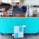 a turquoise blue coffee cart with coffee syrups and the Breville Barista Touch espresso machine