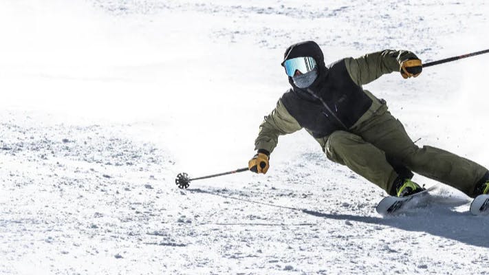 A skier turning down a snowy slope. 
