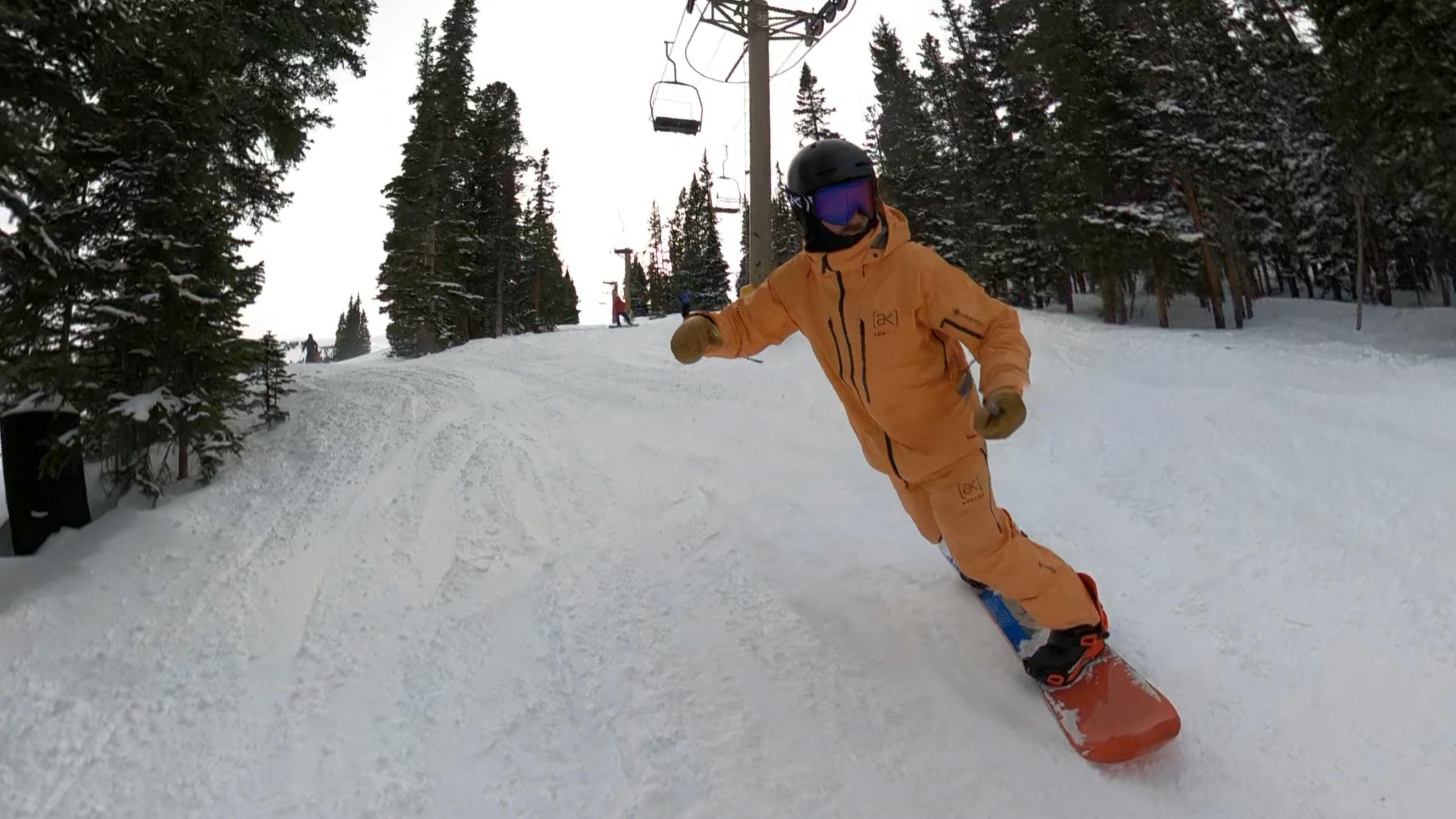 A snowboarder on the CAPiTA The Outsiders Snowboard. 