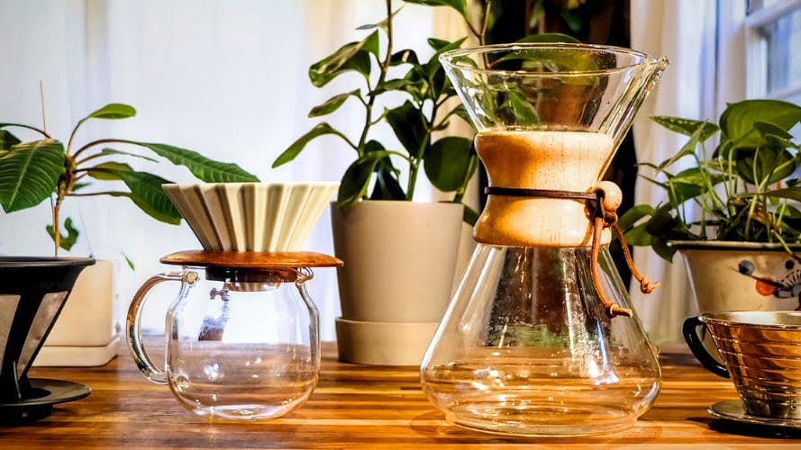 Pour over coffee makers in a row on a counter. 