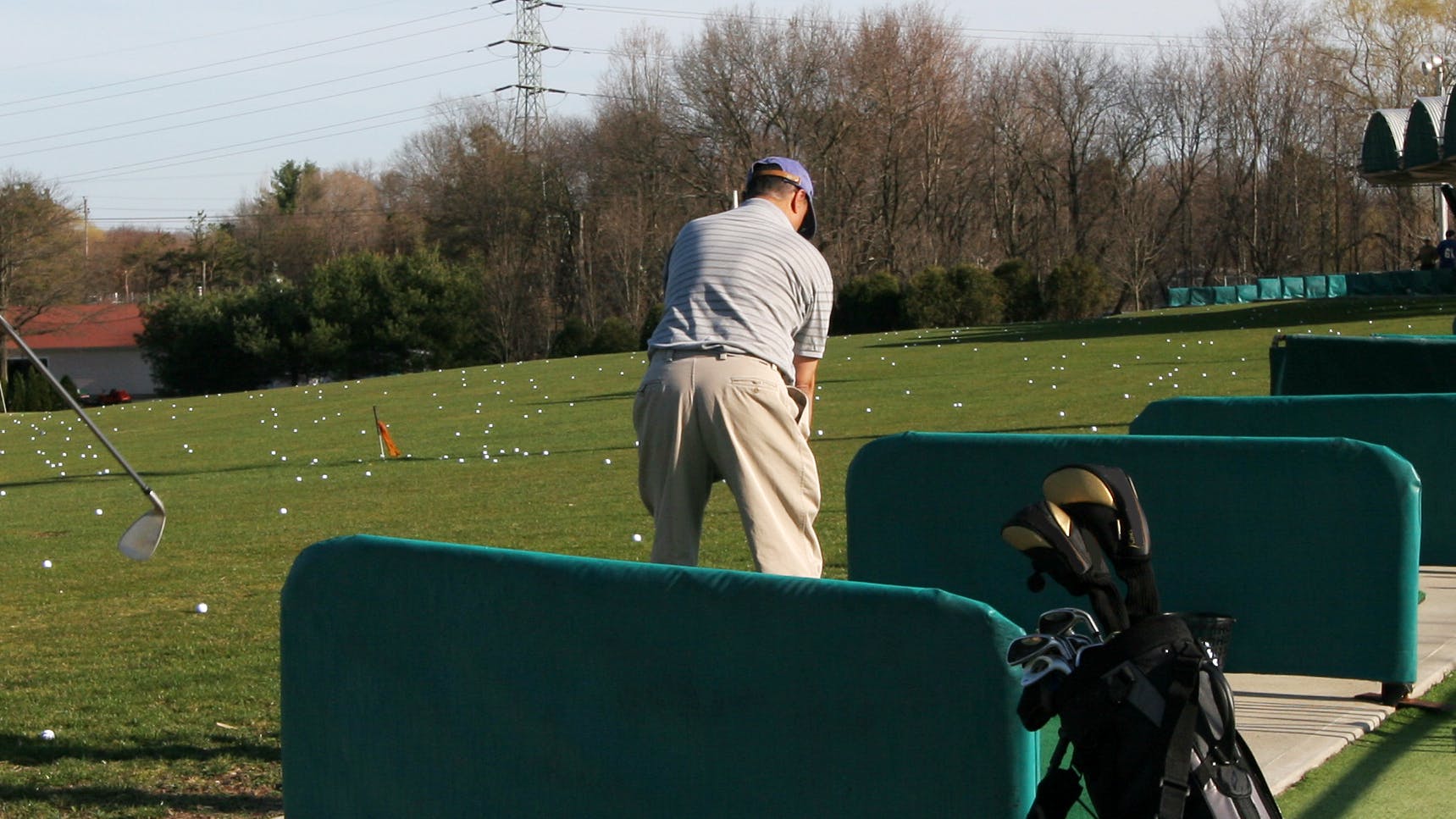 View of several golfers on a driving range. 