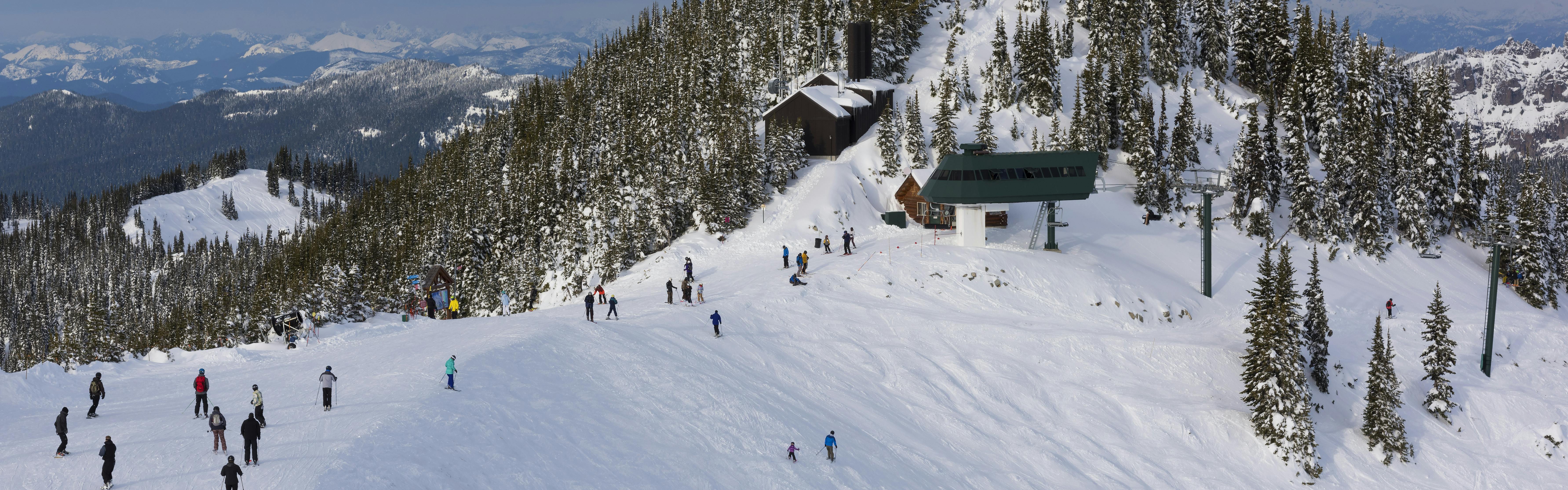 Skiers at the top of a ski lift at Crystal Mountain ski resort. 