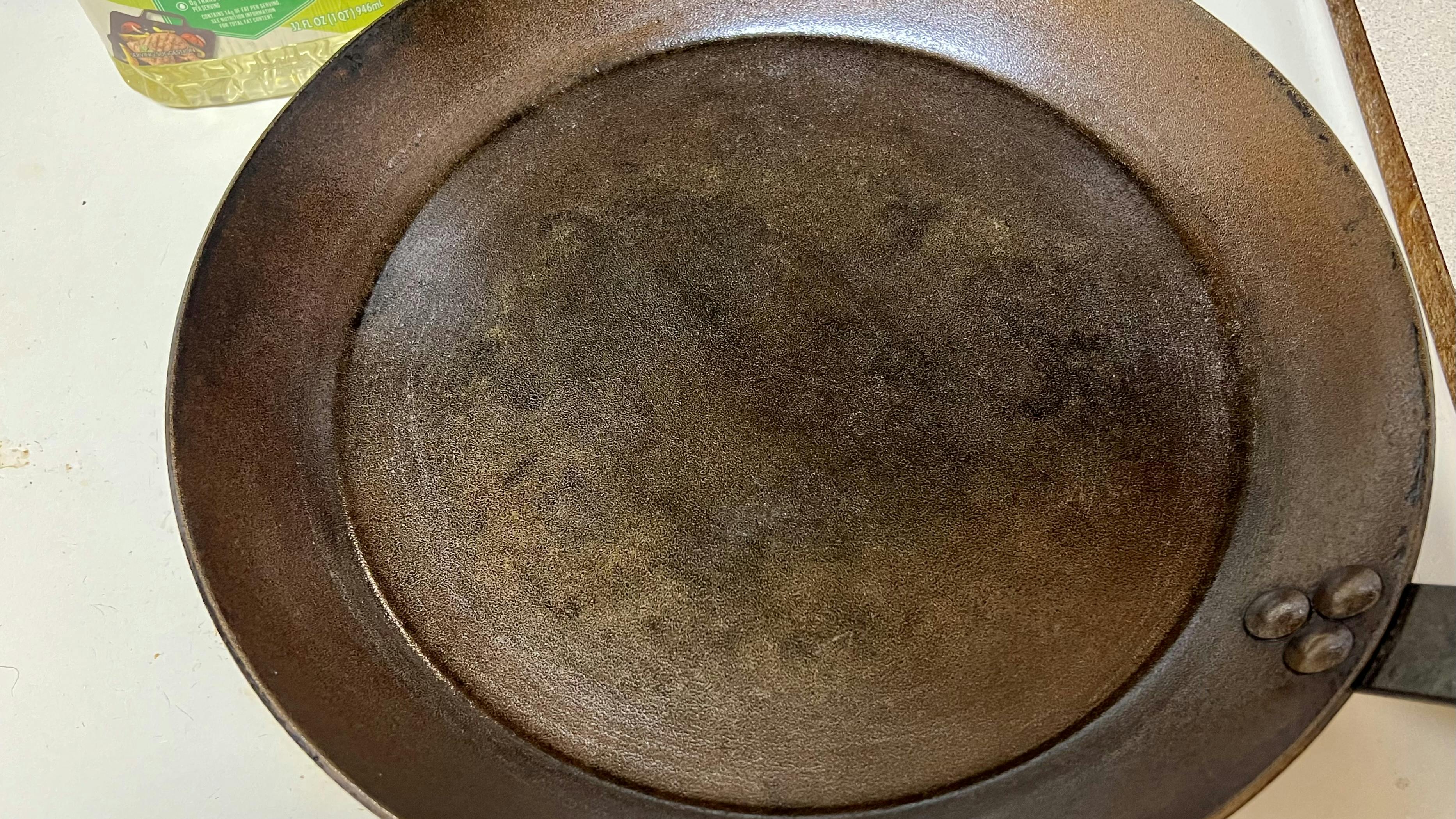 A carbon steel pan with a thin coat of oil.