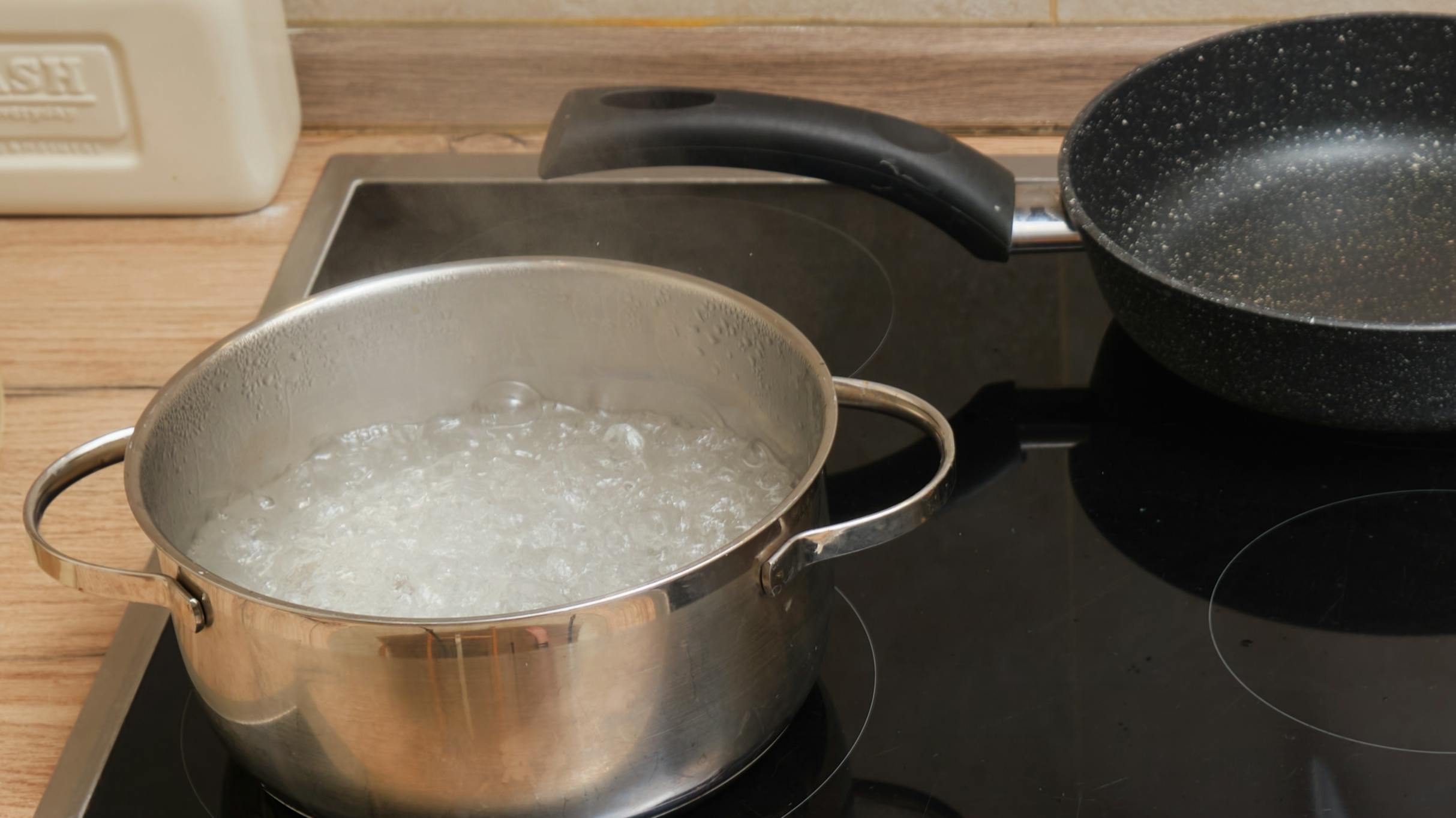 A nonstick pan and stainless steel pan on a stove. 