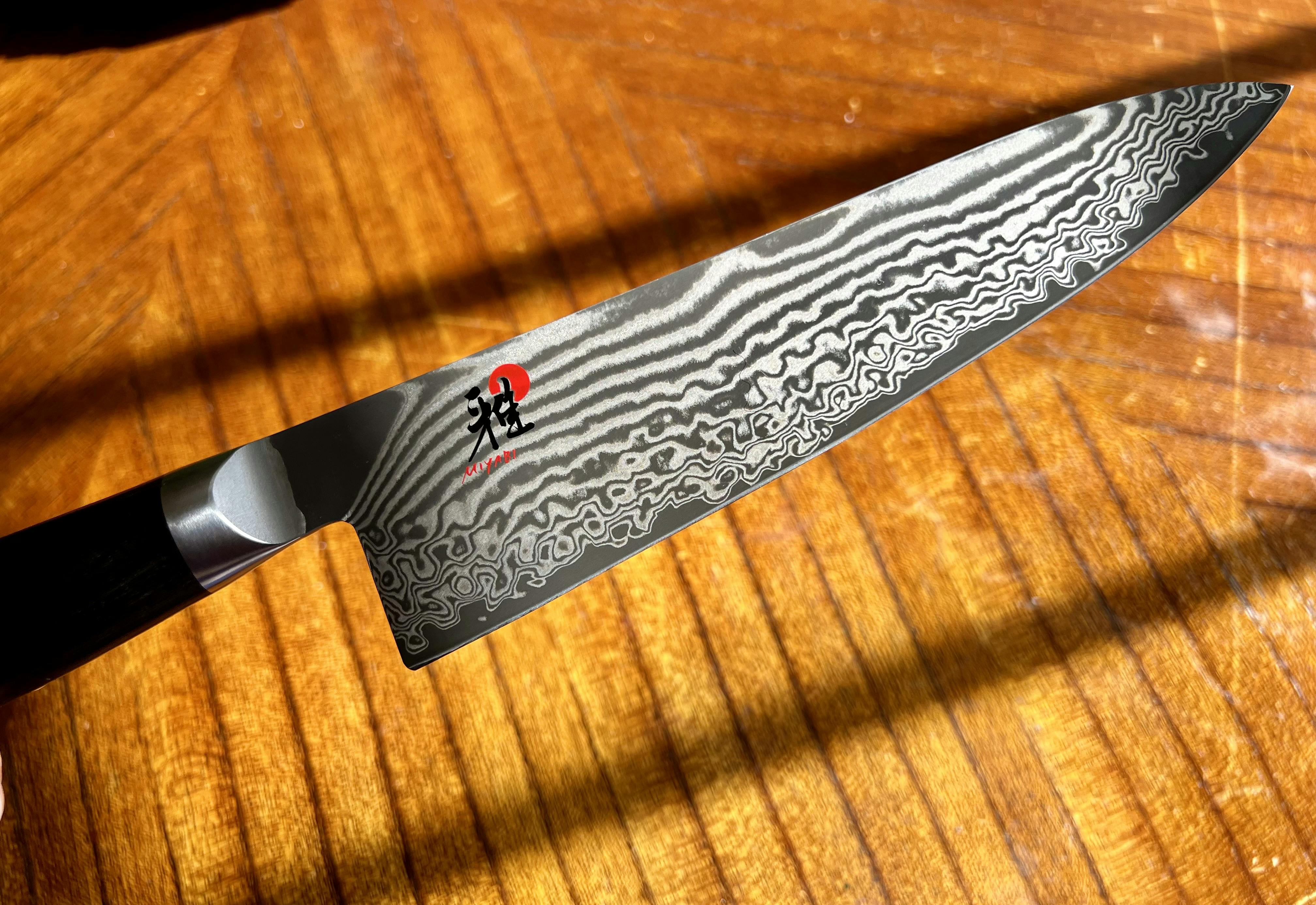 A close up of a Miyabi chef knife.