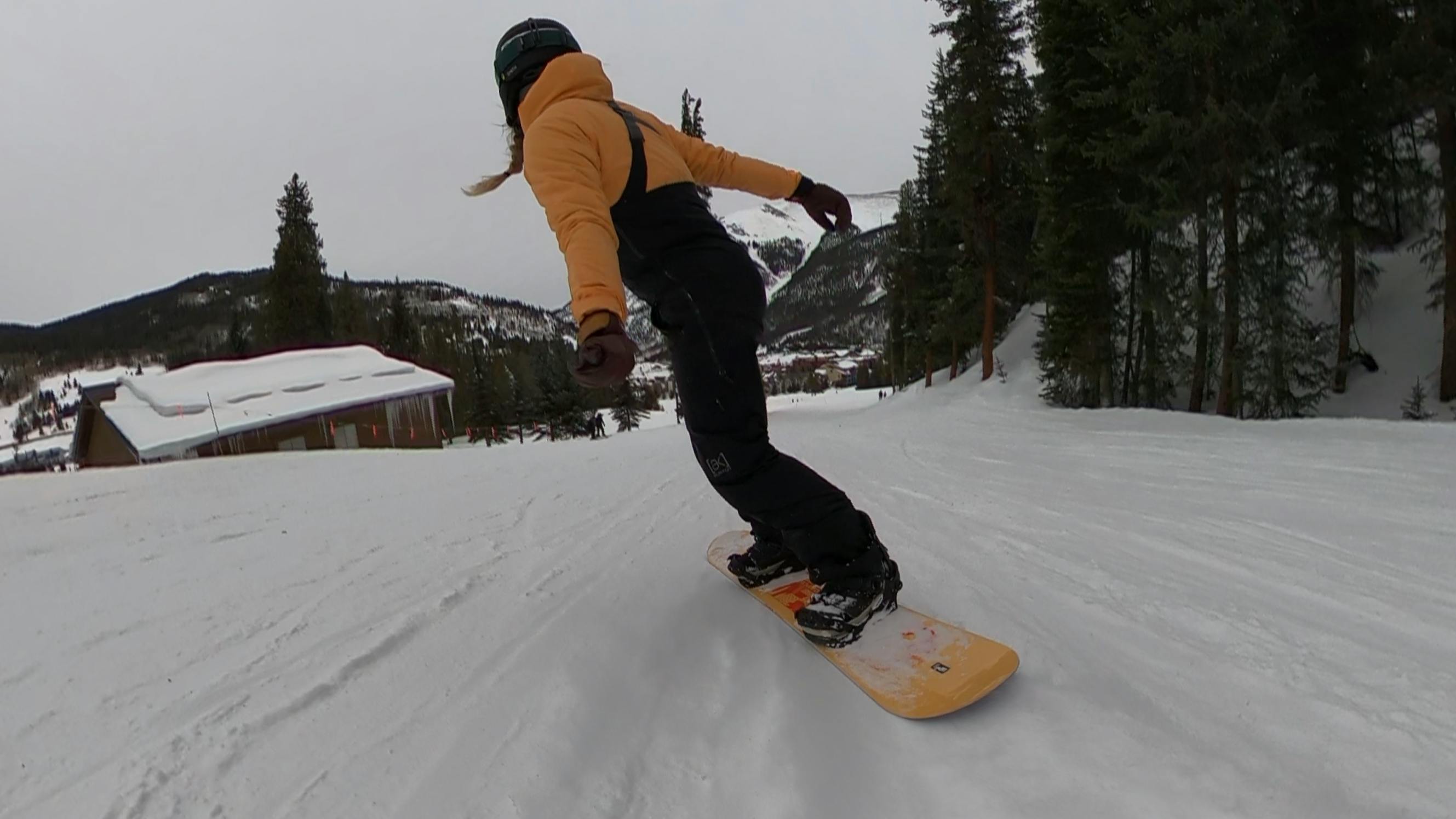 A snowboarder on the CAPiTA Paradise Snowboard. 